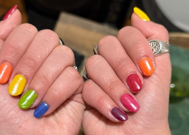 Colorful manicure at Clawed By Clarice in New York, New York, US showcasing vibrant rainbow nails.