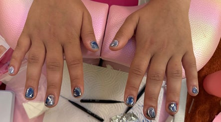 Blue marbled nails at Clawed By Clarice, New York, New York, US, offering creative nail art.