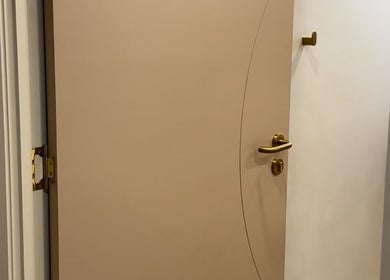 Elegant beige door with golden handle at LIP HAUS, Annerley, Queensland, AU.