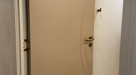 Elegant beige door with golden handle at LIP HAUS, Annerley, Queensland, AU.