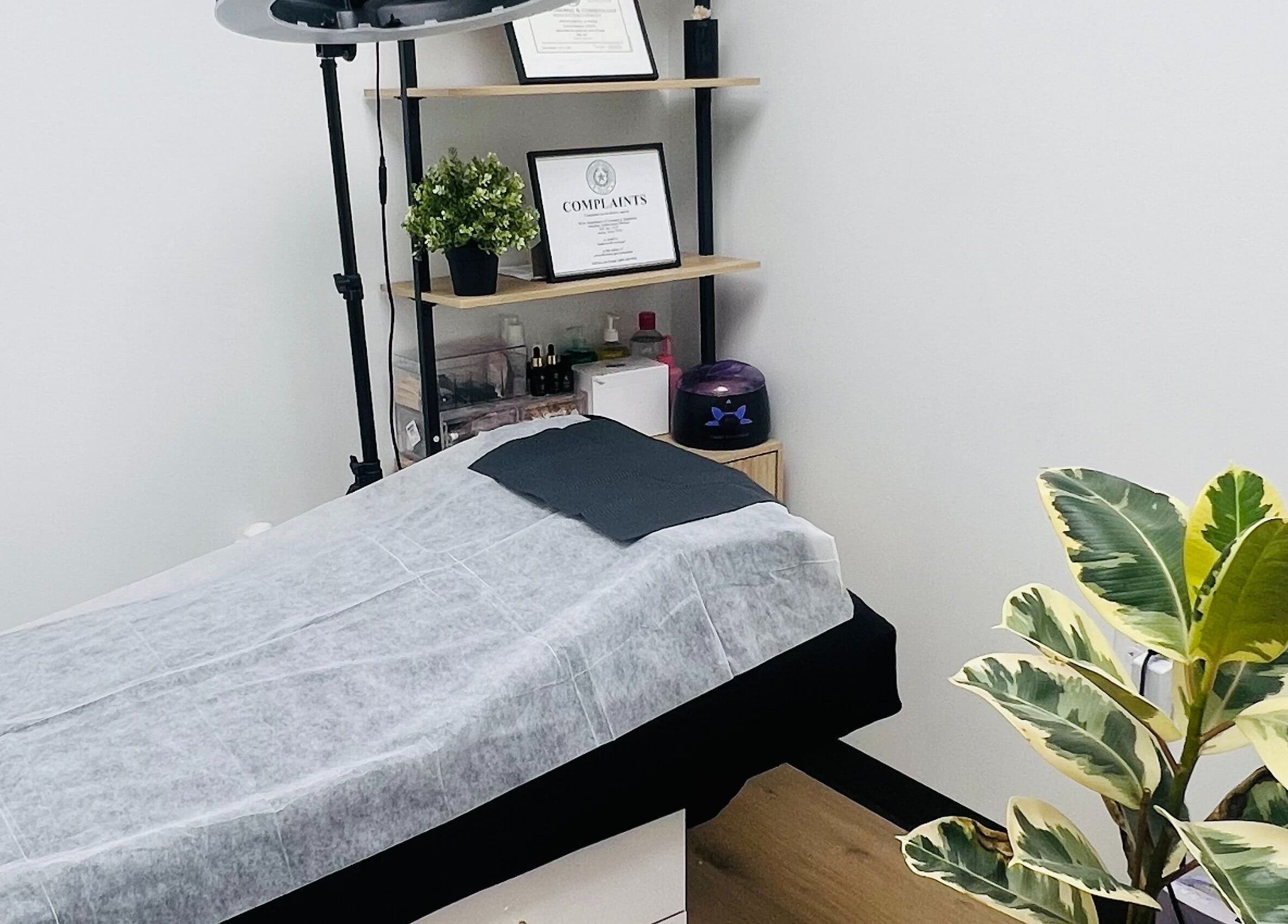 Calm treatment room at Phanlashtic & Nails Studio, Richmond, Texas, US, with a massage table and plants.
