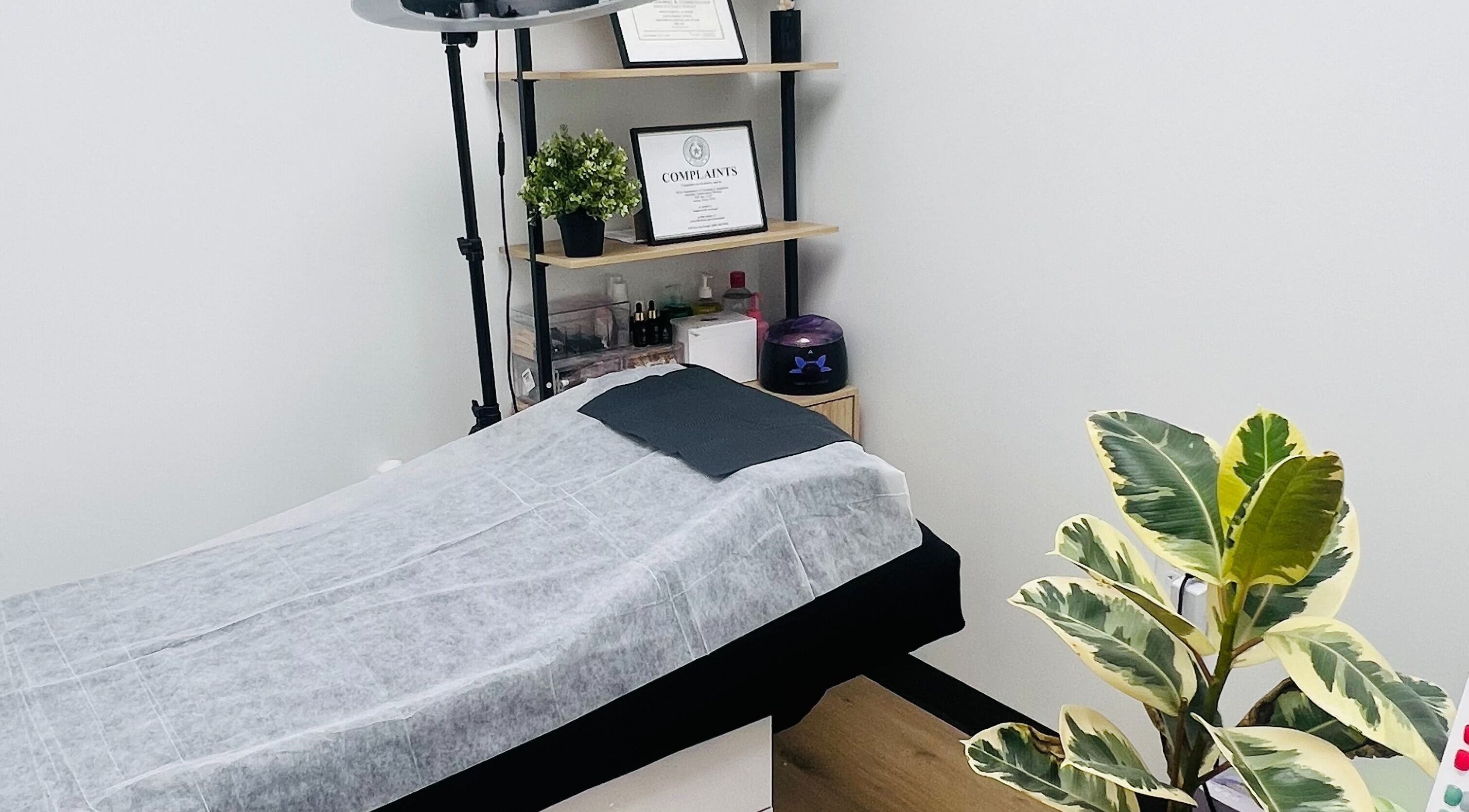 Calm treatment room at Phanlashtic & Nails Studio, Richmond, Texas, US, with a massage table and plants.