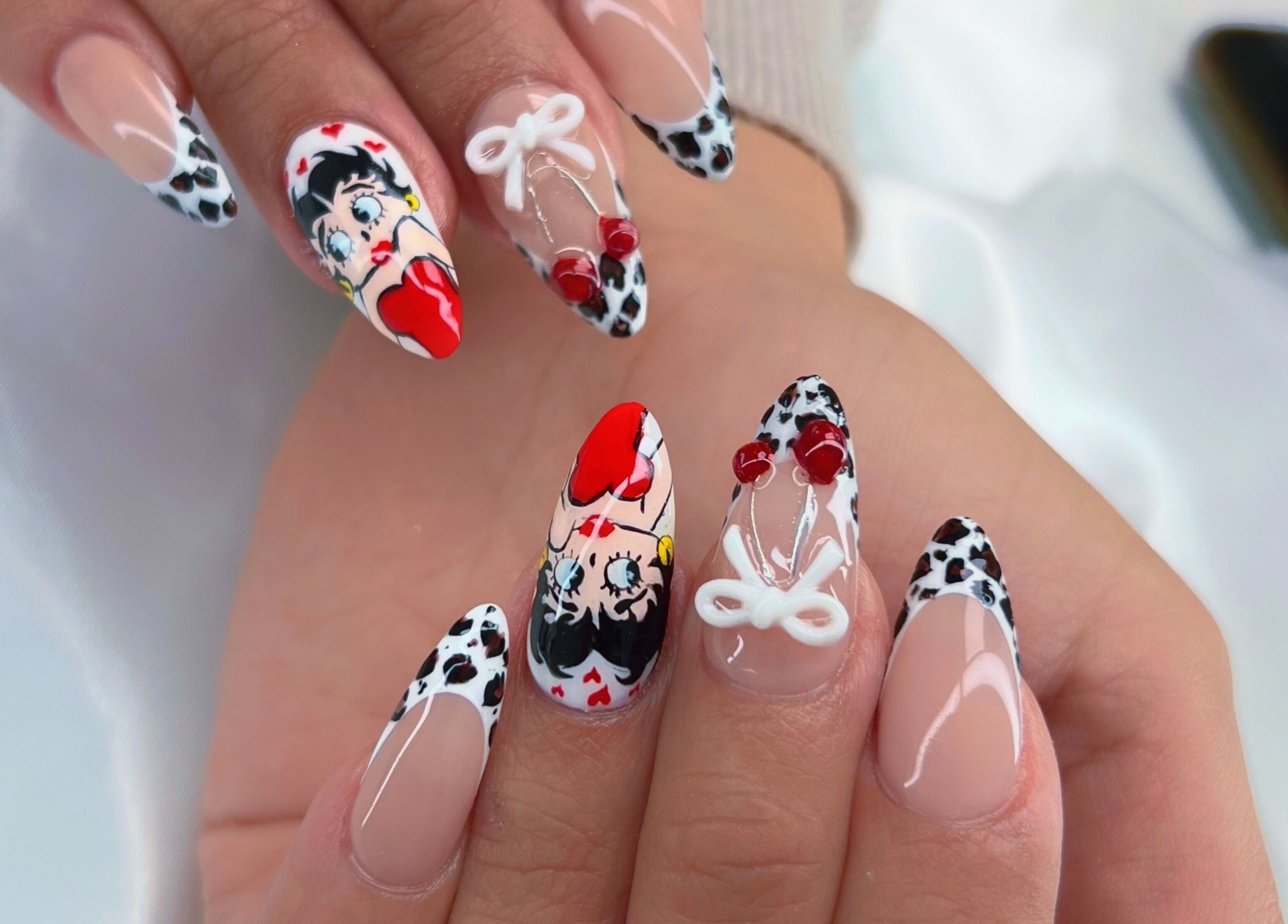 Colorful nail art design at Phanlashtic & Nails Studio, Richmond, Texas, US, featuring detailed cartoon imagery.