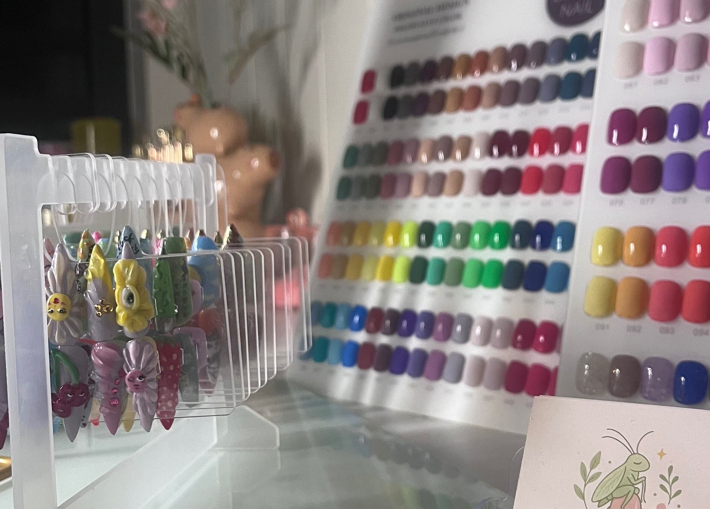 Diverse nail art collection at Cuticle Cricket in Erskinville, New South Wales, AU featuring colorful designs.