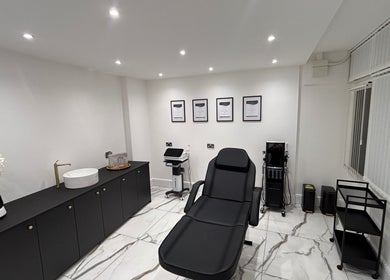 SKIN GODS beauty treatment room with sleek black chair and decor in Warrington, England, GB.