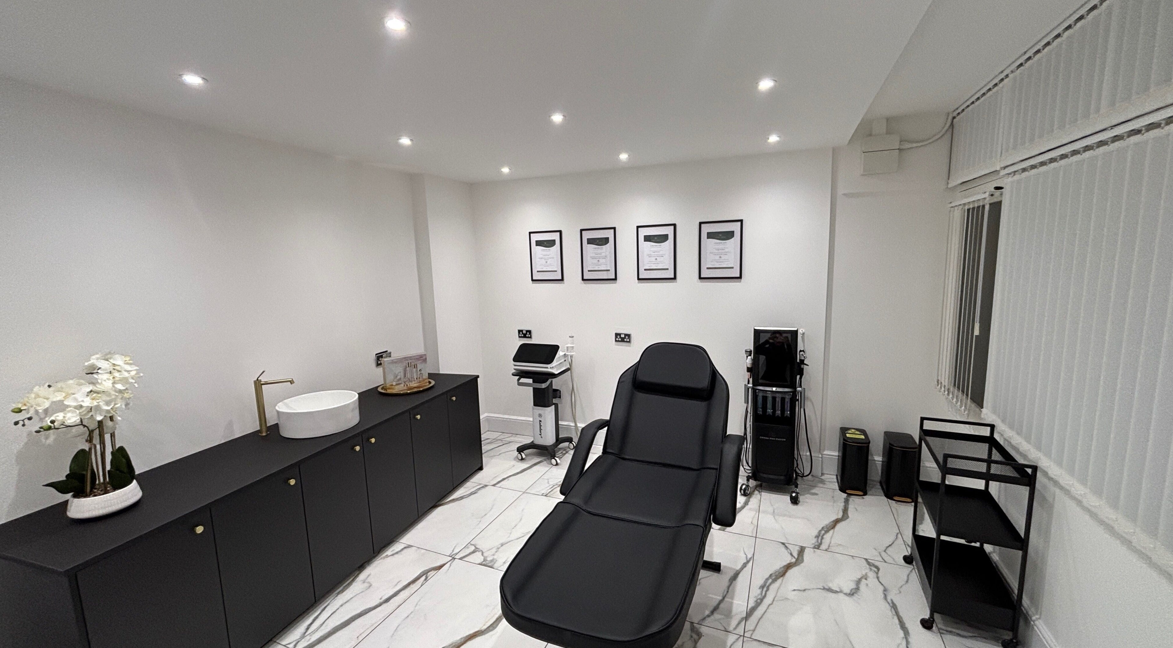 SKIN GODS beauty treatment room with sleek black chair and decor in Warrington, England, GB.