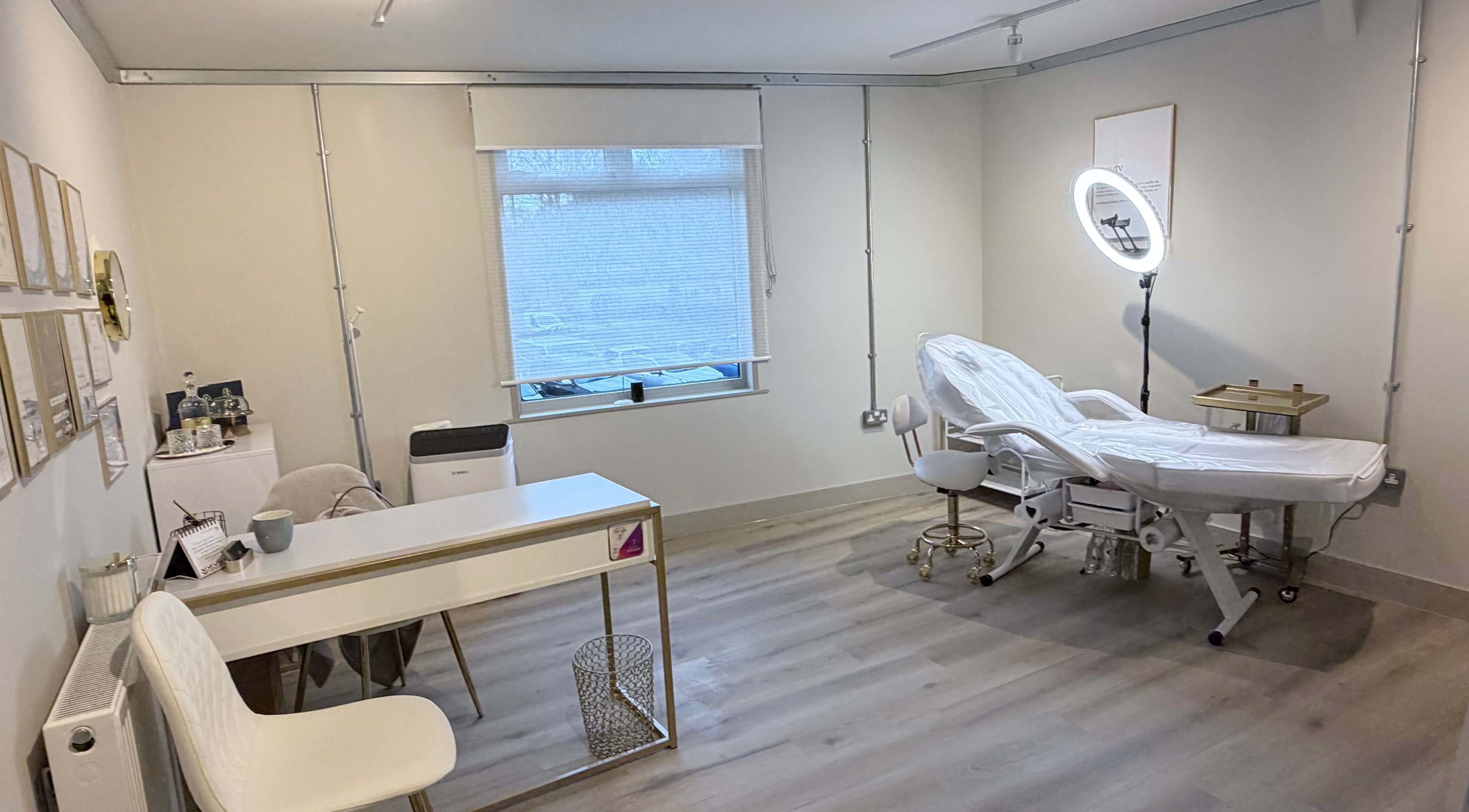 Bright treatment room at Beauty Poem, Droitwich, England, GB, featuring a comfortable bed and chic decor.