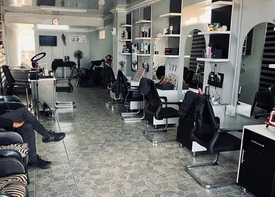 Spacious salon interior at FreshStyleBeautyHub in Thembisa, Gauteng, ZA, featuring modern styling stations.