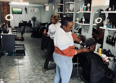 Inside FreshStyleBeautyHub in Thembisa, Gauteng, ZA showcasing modern styling stations and clients being served.