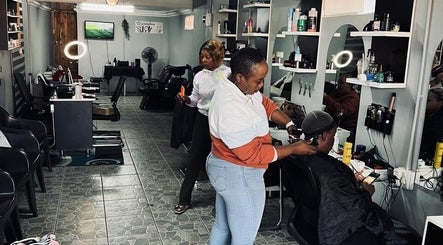 Inside FreshStyleBeautyHub in Thembisa, Gauteng, ZA showcasing modern styling stations and clients being served.