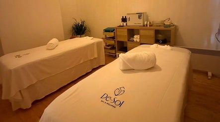 Couples massage room at Desol Spa and Wellness, Melbourne, Victoria, AU, featuring two beds and relaxing decor.