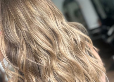 Golden wavy hair styled at LMS HAIR in Welling, England, GB, showcasing elegant highlights.