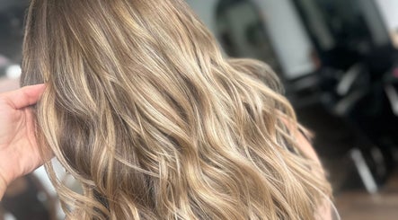 Golden wavy hair styled at LMS HAIR in Welling, England, GB, showcasing elegant highlights.