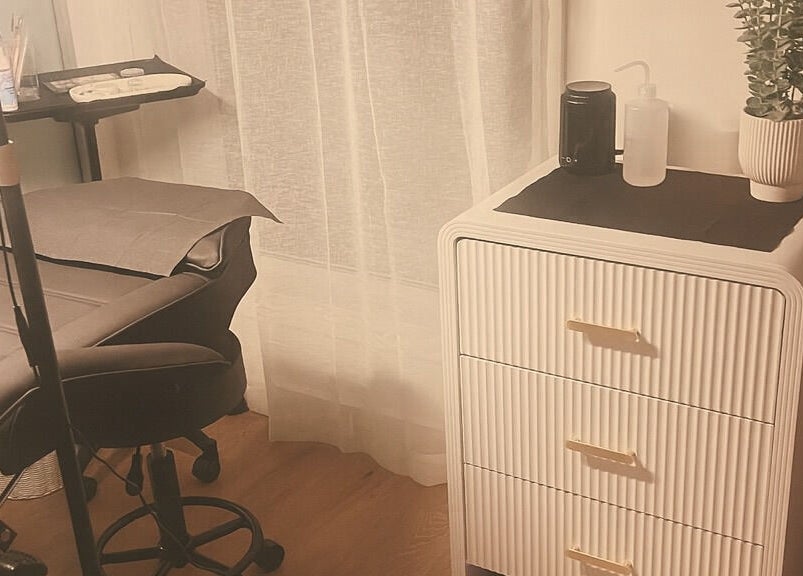 Cozy treatment room at TW BROWS, Claremont Meadows, New South Wales, AU, featuring a comfortable chair and chic decor.