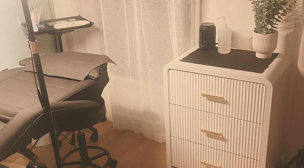 Cozy treatment room at TW BROWS, Claremont Meadows, New South Wales, AU, featuring a comfortable chair and chic decor.