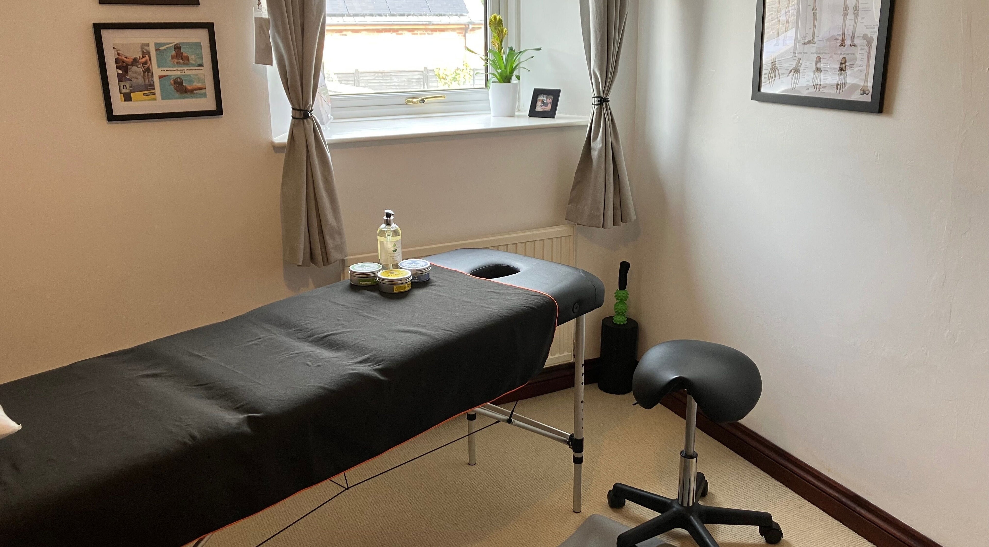 Massage room at HBW Sports Massage, Lower Westford, England, GB, featuring a treatment table and cozy ambiance.