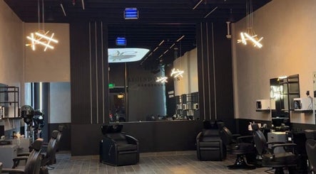 Modern interior of Legendary Cuts Barbershop in Riyadh, SA with stylish chairs and ambient lighting.