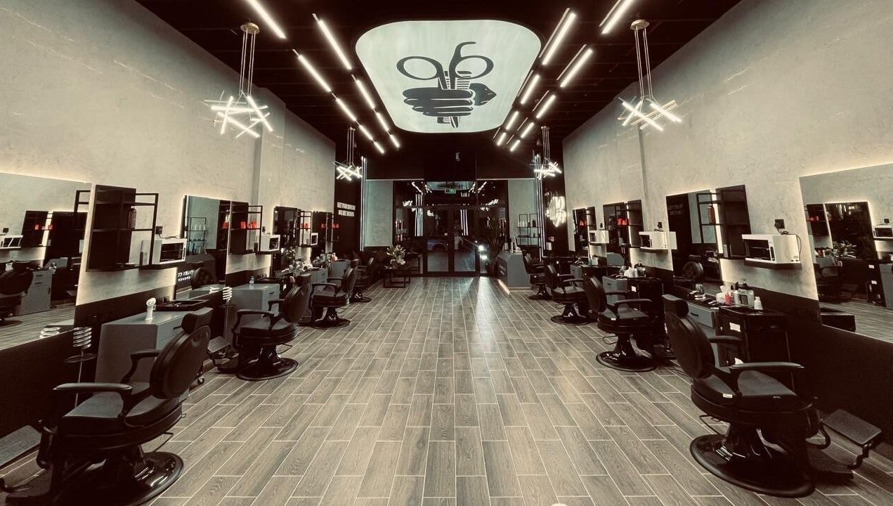 Modern interior of Legendary Cuts Barbershop in Riyadh, SA, featuring sleek barber chairs and elegant lighting.