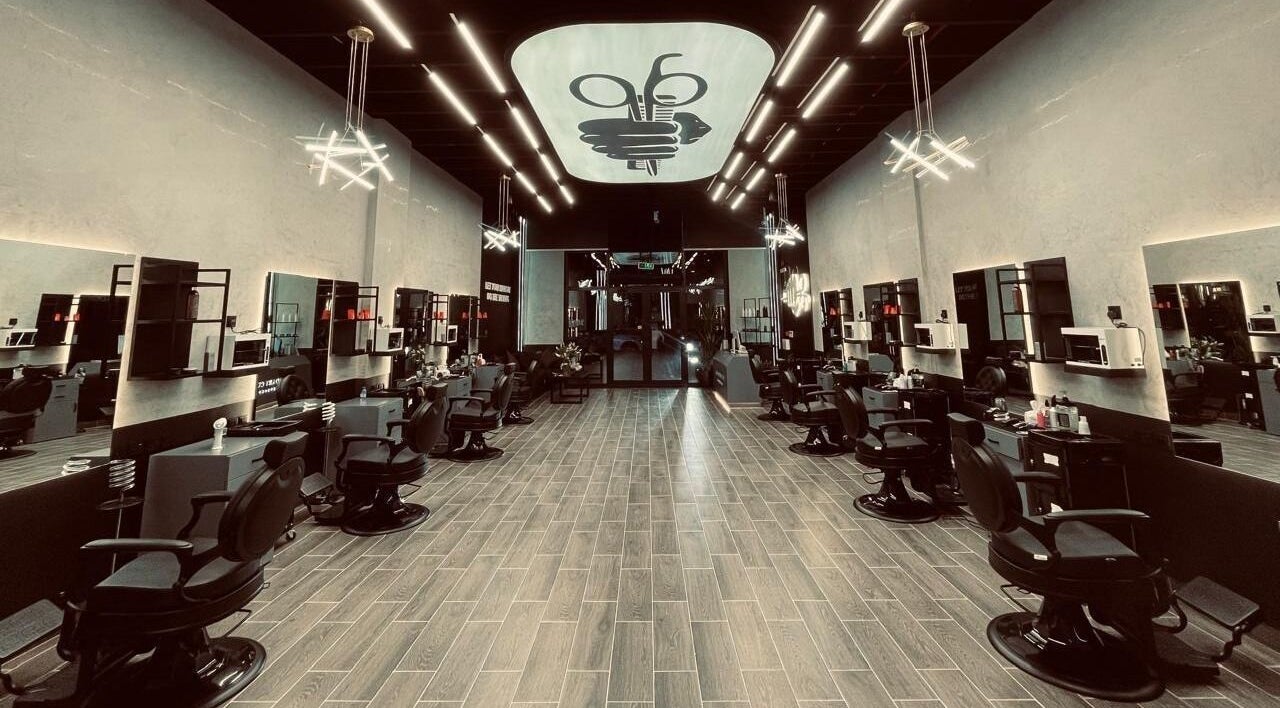 Modern interior of Legendary Cuts Barbershop in Riyadh, SA, featuring sleek barber chairs and elegant lighting.