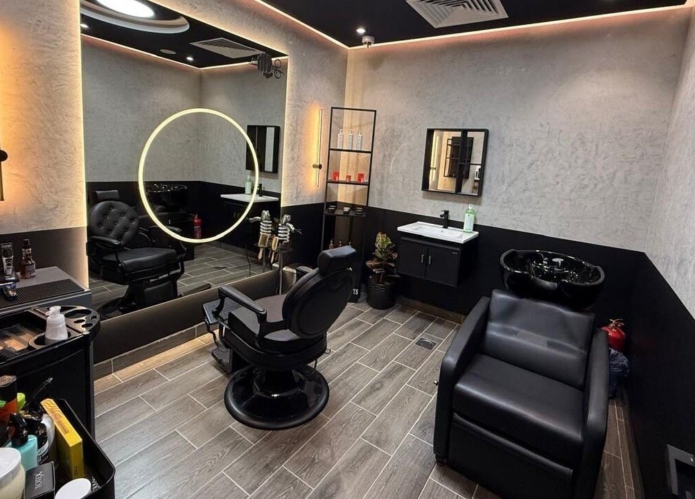 Modern interior of Legendary Cuts Barbershop in Riyadh, SA showcasing stylish chairs and elegant lighting.