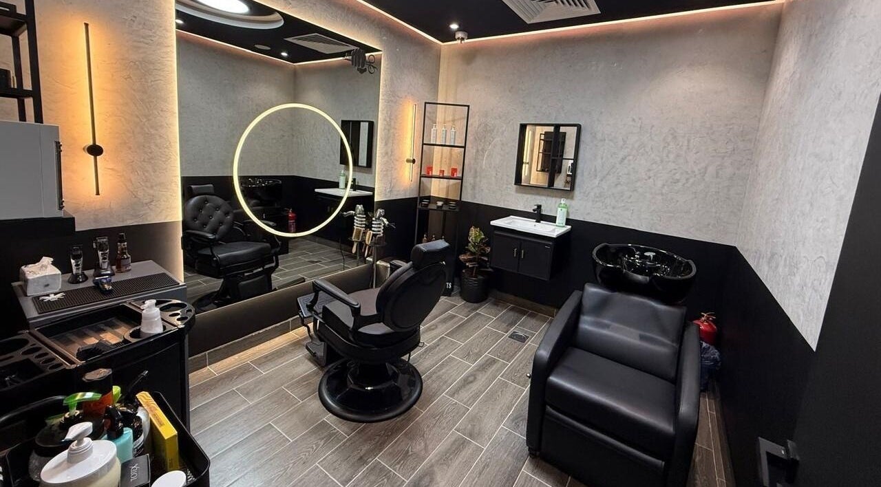 Modern interior of Legendary Cuts Barbershop in Riyadh, SA showcasing stylish chairs and elegant lighting.