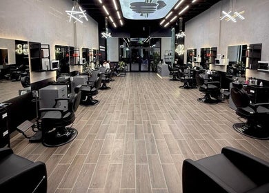 Elegant interior of Legendary Cuts Barbershop in Riyadh, SA features modern chairs and stylish decor.