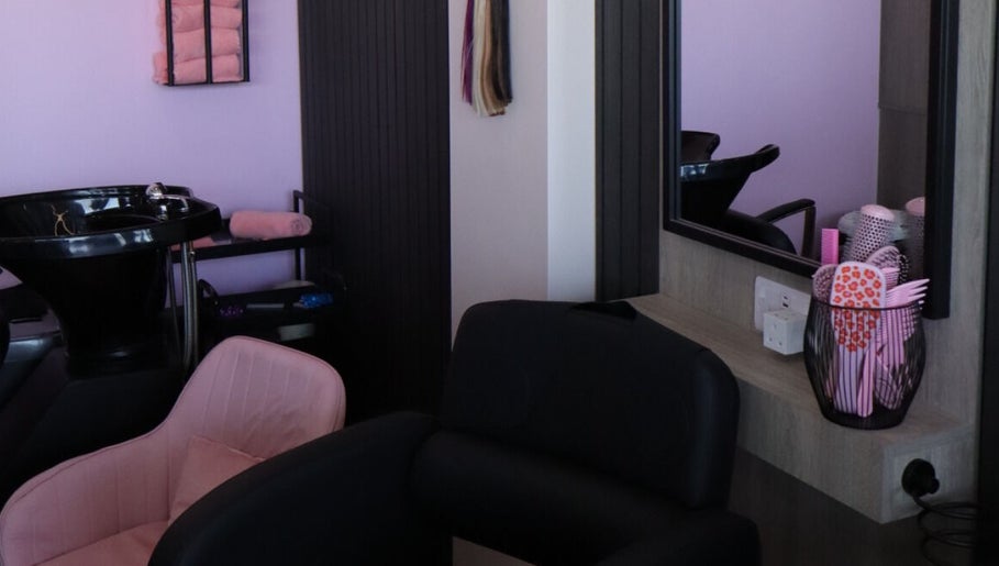 Cozy beauty station at The Pink Edit, Bournemouth, England, GB, featuring pink chairs and stylish decor.