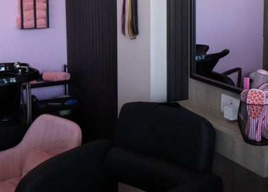 Cozy beauty station at The Pink Edit, Bournemouth, England, GB, featuring pink chairs and stylish decor.