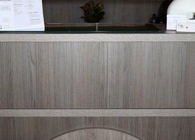 The Pink Edit's chic wooden reception desk in Bournemouth, England, GB welcomes clients with style.