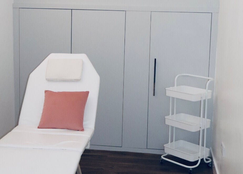 Luxury treatment room at The Pink Edit in Bournemouth, England, GB, featuring a plush chair and pastel decor.