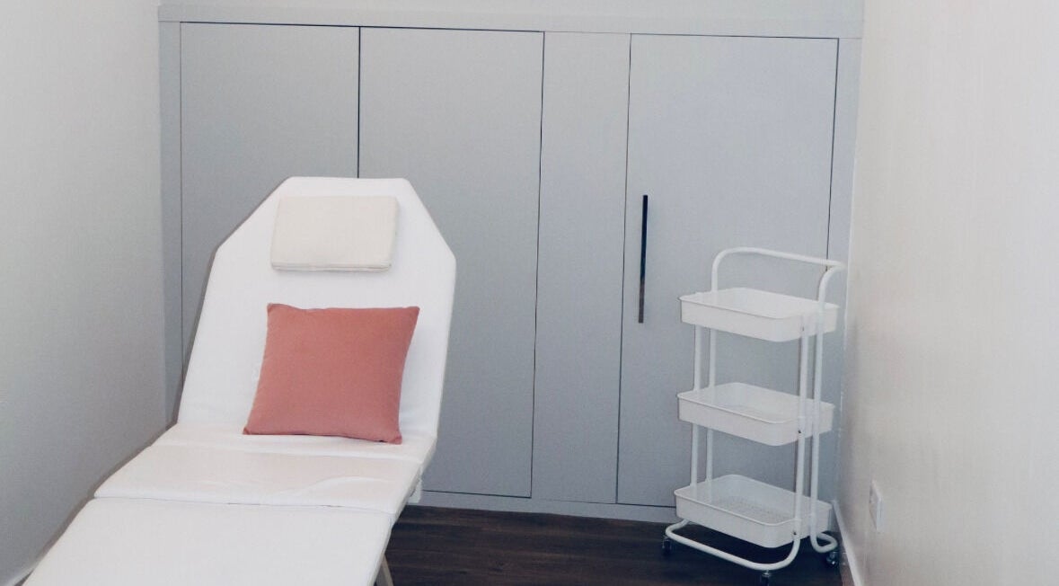 Luxury treatment room at The Pink Edit in Bournemouth, England, GB, featuring a plush chair and pastel decor.