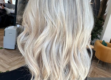 Blonde Bliss salon in Aberdeen, Scotland, features flowing blonde hair styled in soft waves.