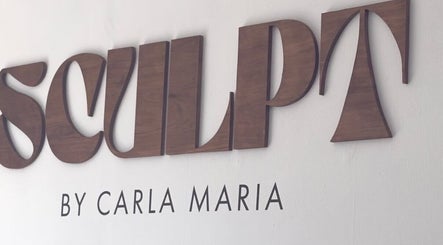 Sculpt sign at ByCarlaMaria in Sutton Coldfield, England, GB, featuring elegant wood lettering.