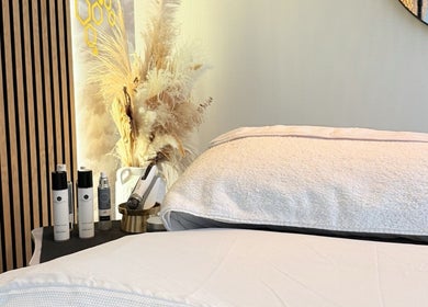 Relaxing treatment room at FaceFIT With Lauren in Inverness, Scotland, GB, featuring cozy bedding and beauty products.