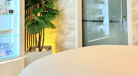Tranquil spa ambience at FaceFIT With Lauren, Inverness, Scotland, GB, featuring a lush plant and treatment table.