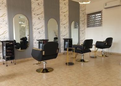 Elegant salon at Ash Hair Story, Accra, Greater Accra Region, GH with modern design and stylish chairs.