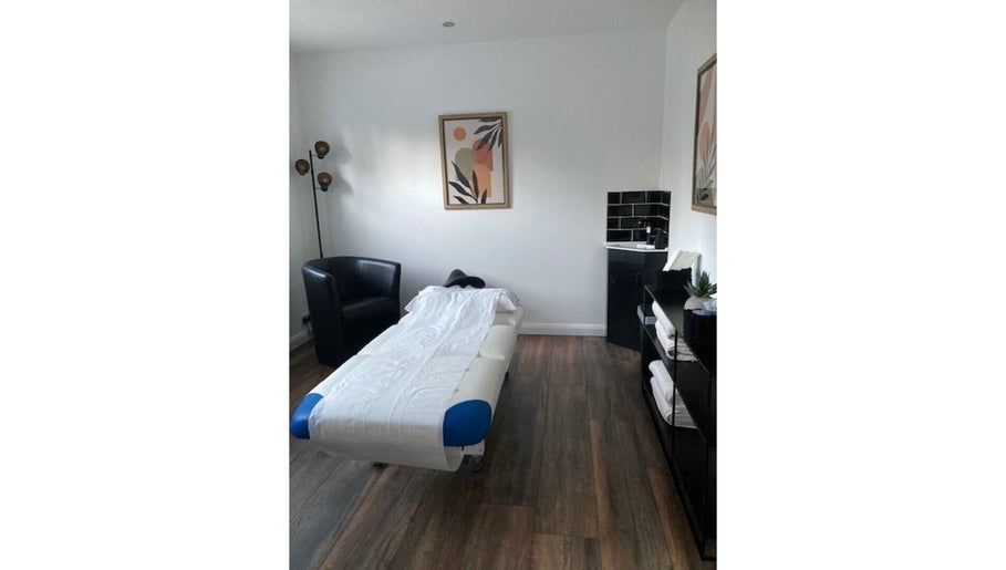 Cozy treatment room at Jo Mitchell Reflexology, Bushey, England, GB with massage bed and soothing decor.
