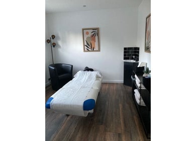 Cozy treatment room at Jo Mitchell Reflexology, Bushey, England, GB with massage bed and soothing decor.