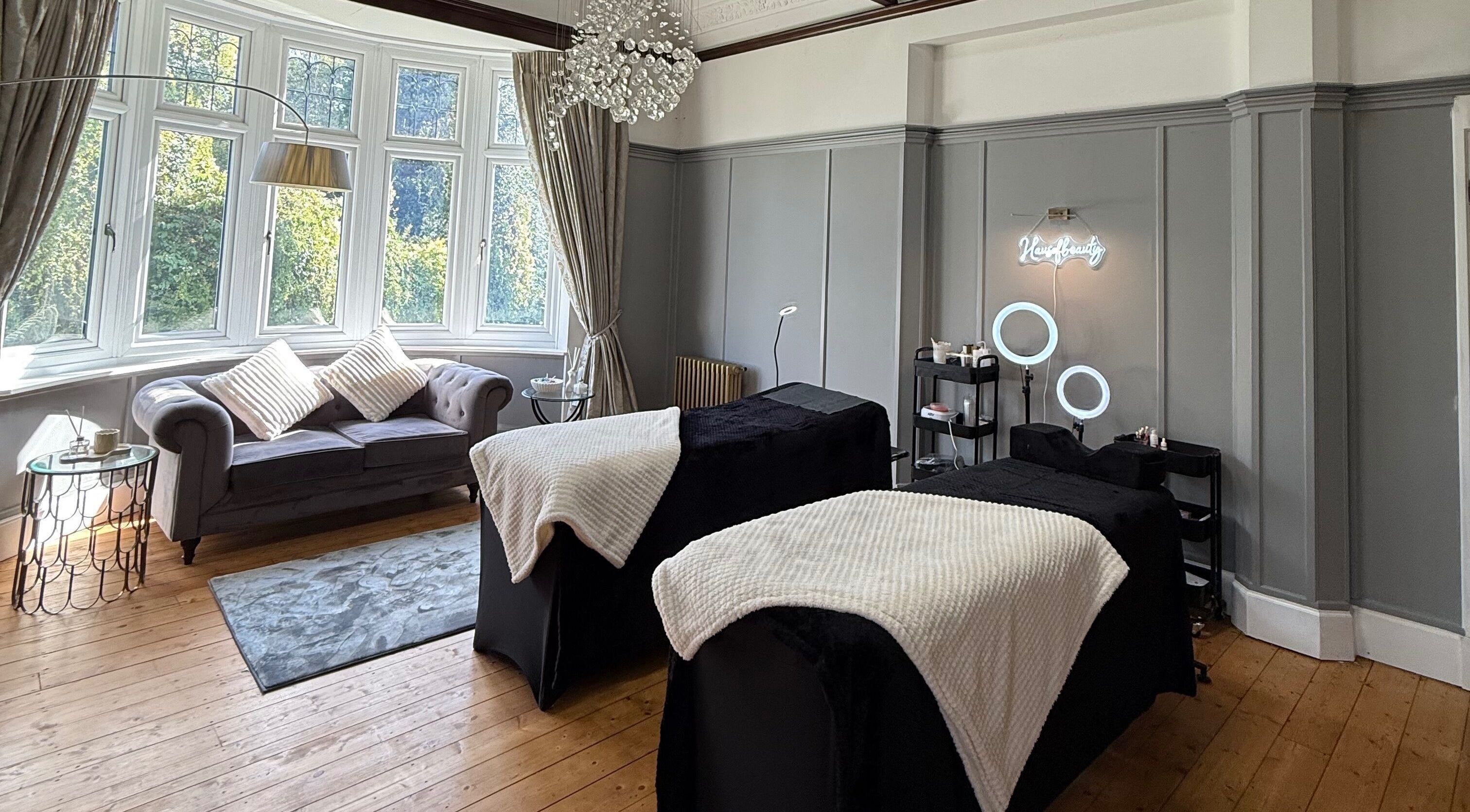 Spacious beauty room at The Lash & Brow Co., Nottingham, England, GB with cozy couches and modern decor.