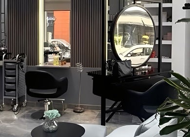 Modern interior of Mirka Studio Academy, Tiranë, Qarku I Tiranës, AL featuring stylish salon chairs and decor.