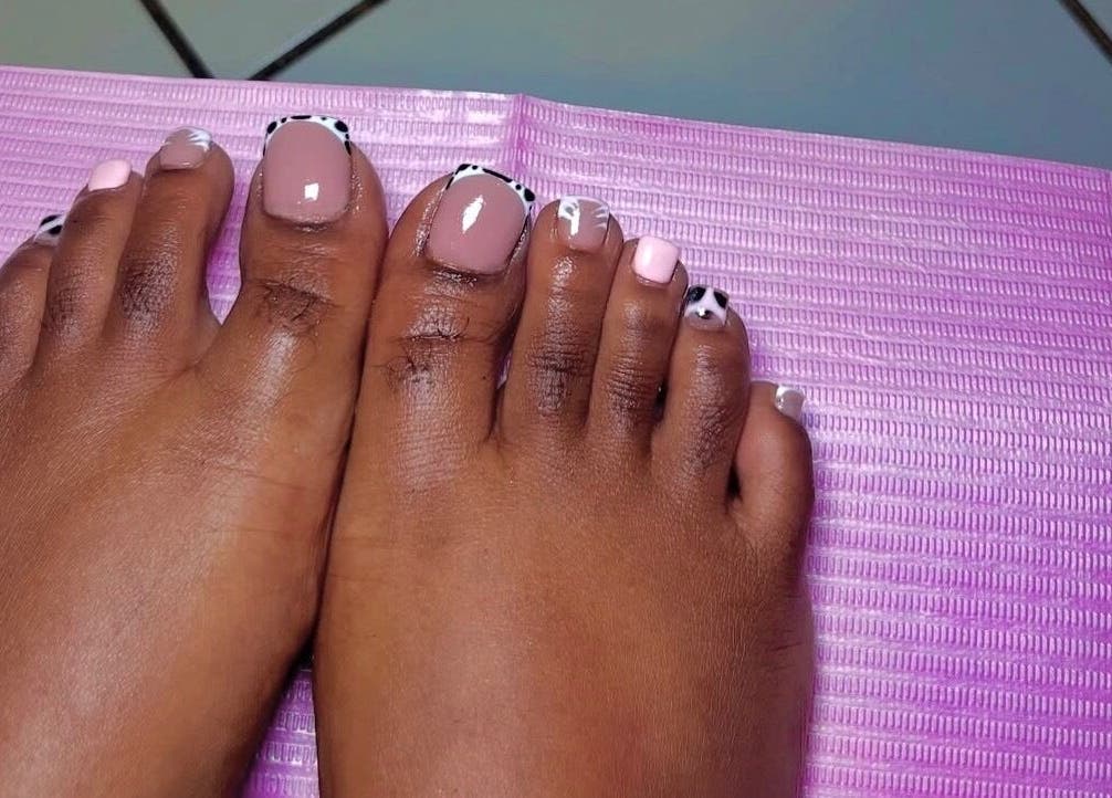 Stylish pedicure at T&K Blissfull beauty spot, St. Ann Parish, JM, featuring pink and patterned nails.