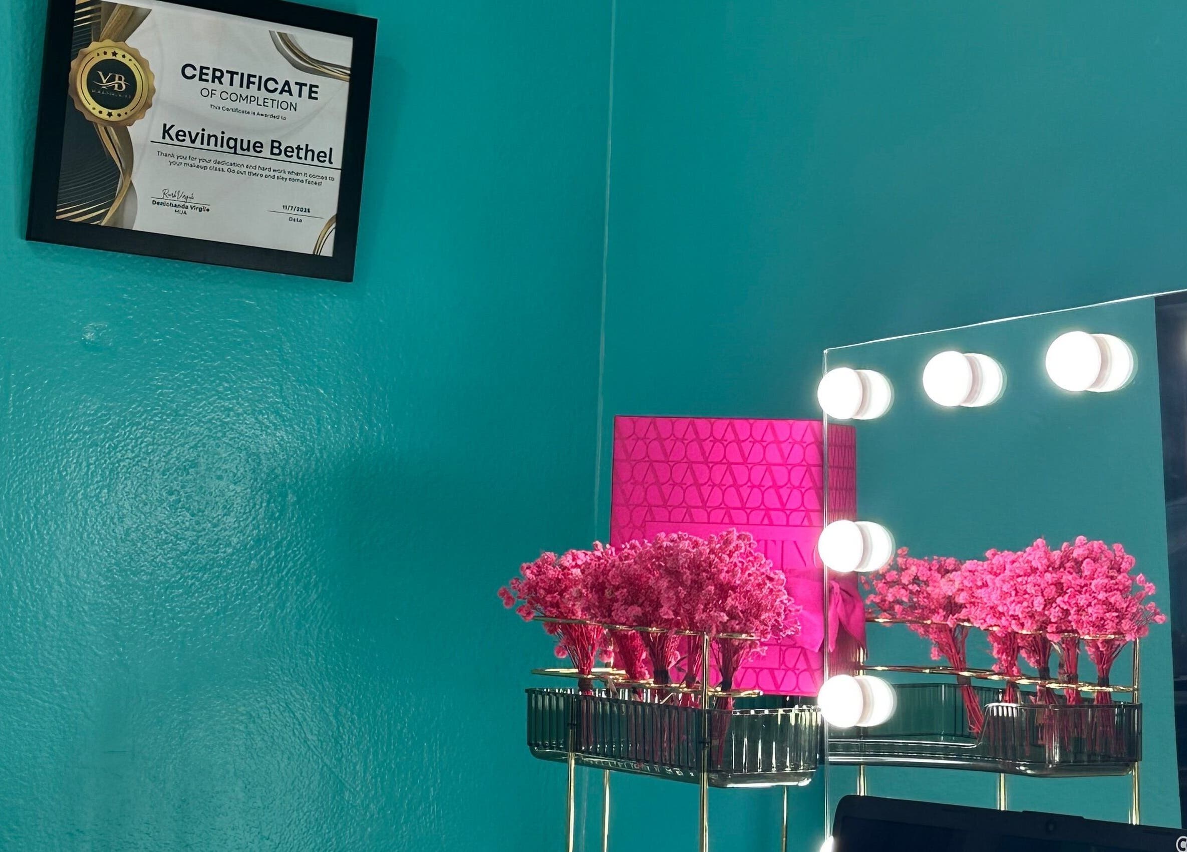 Elegant vanity setup at Hair Infirmary242, Nassau, New Providence, BS, featuring a mirror with lights and decor.