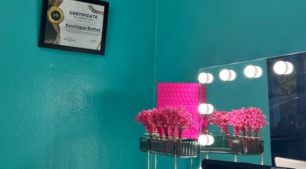 Elegant vanity setup at Hair Infirmary242, Nassau, New Providence, BS, featuring a mirror with lights and decor.