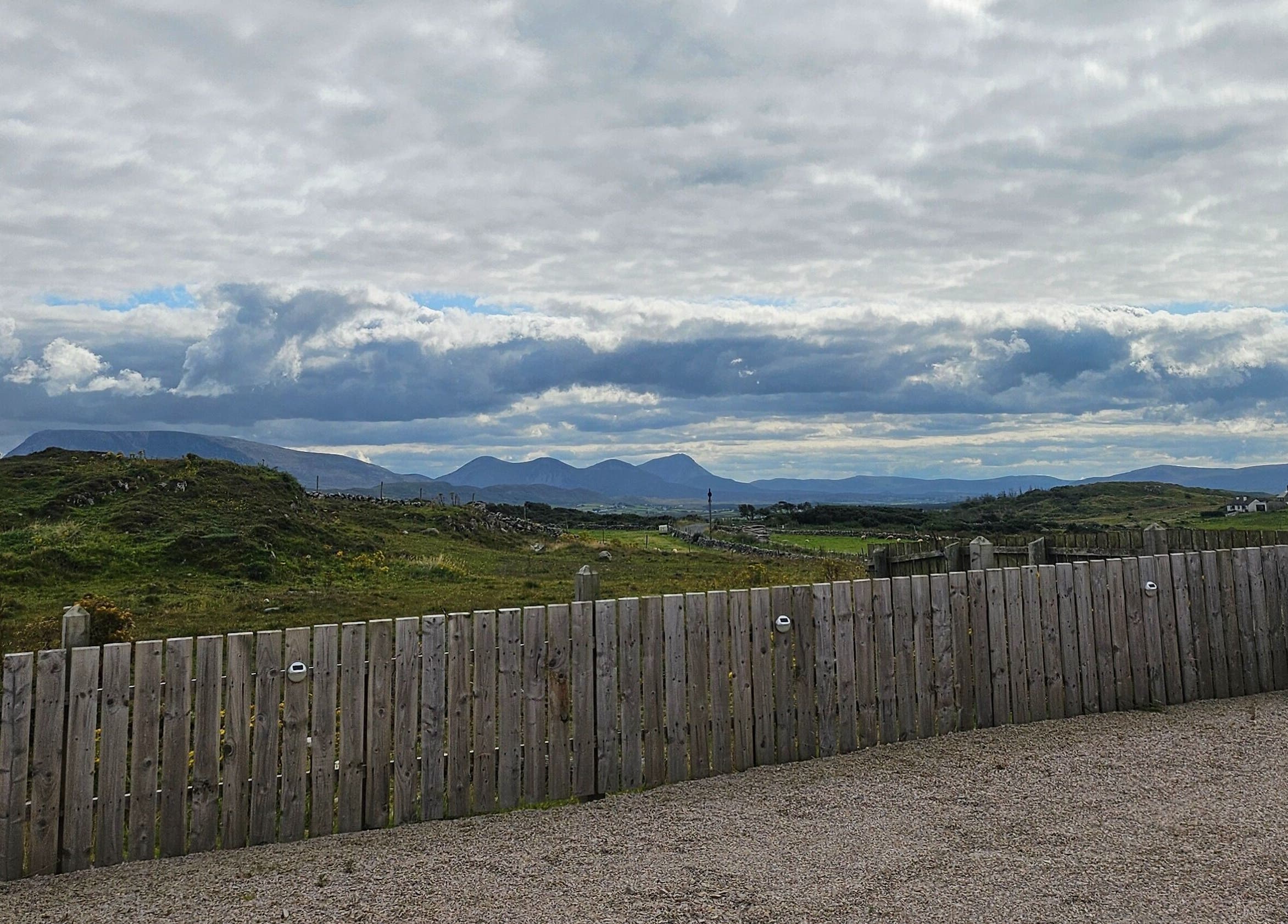 Scenic view from Bella Dama Beauty Studio, County Donegal, IE, featuring lush hills and a serene sky.