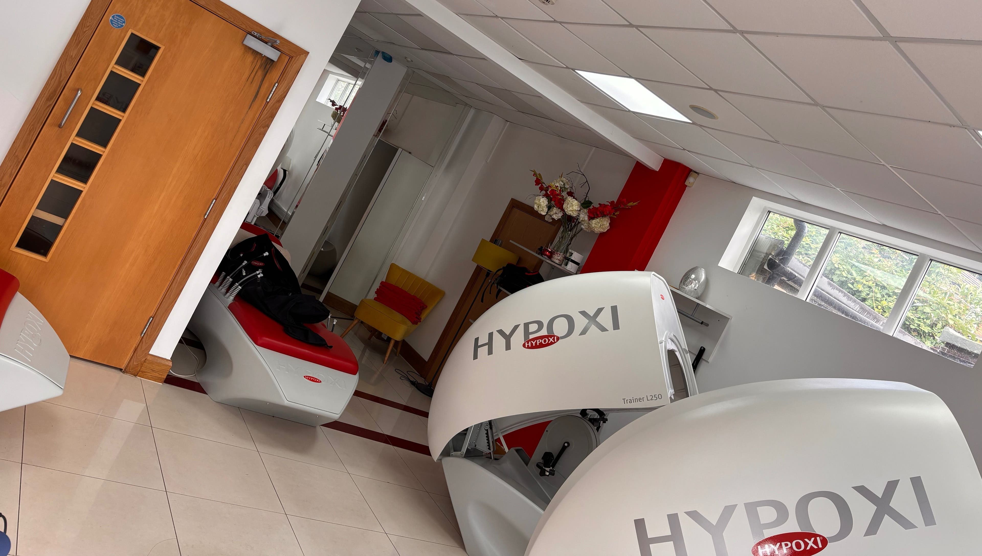Modern interior of Hypoxi Slim Suite in Ascot, England with advanced fitness equipment and elegant decor.