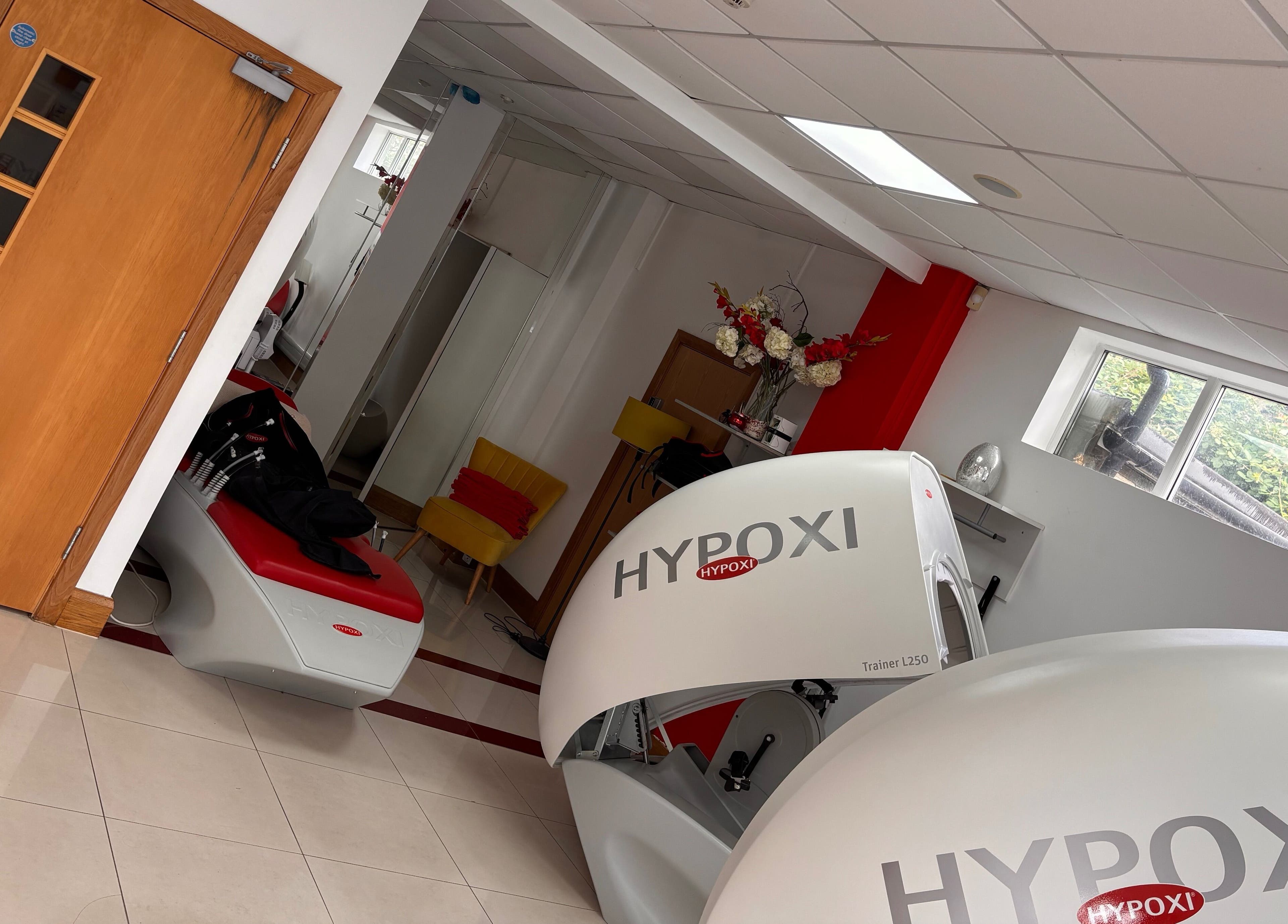 Modern interior of Hypoxi Slim Suite in Ascot, England with advanced fitness equipment and elegant decor.