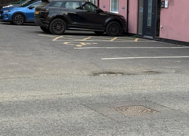 Parking area outside Elite Medical, Sports Therapy and Ear Care, Shaw, England, GB, showcasing entrance.