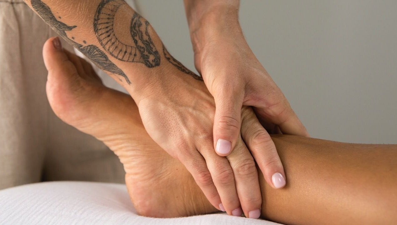 Therapist performing a soothing foot massage at Lymph by Camila, Lisbon, Lisbon, PT.