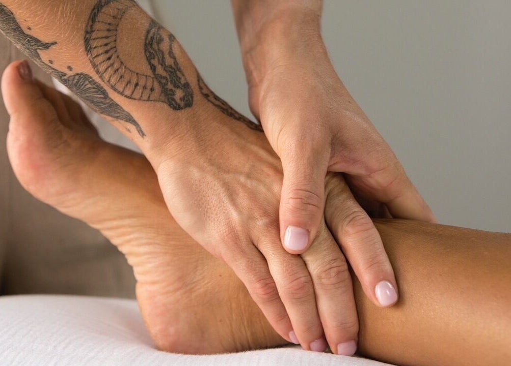 Therapist performing a soothing foot massage at Lymph by Camila, Lisbon, Lisbon, PT.