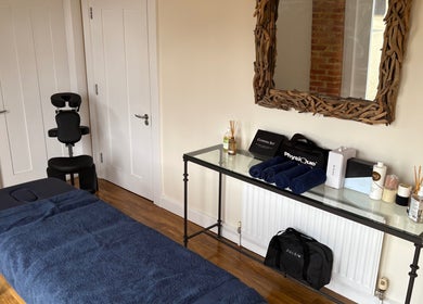 Treatment room at SRSportsRehab in Silverstone, England, GB with massage table and wellness products.